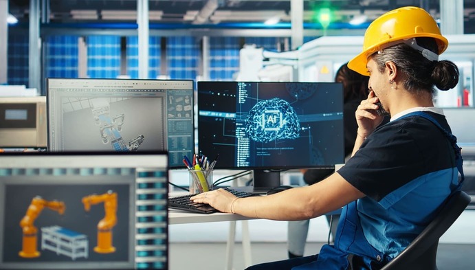 Factory automation engineer programming robotic systems and monitoring smart manufacturing processes