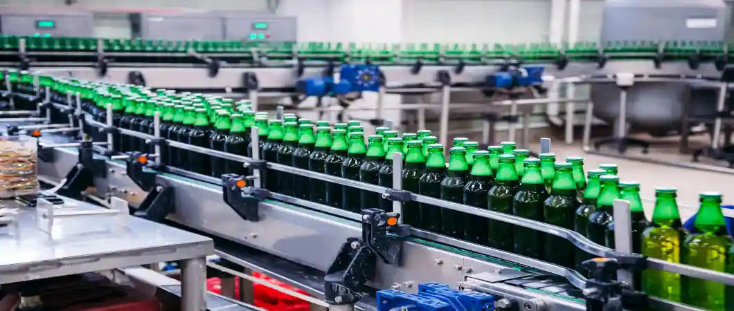 Industrial bottling and packaging machinery automating glass bottle filling, handling, and production processes
